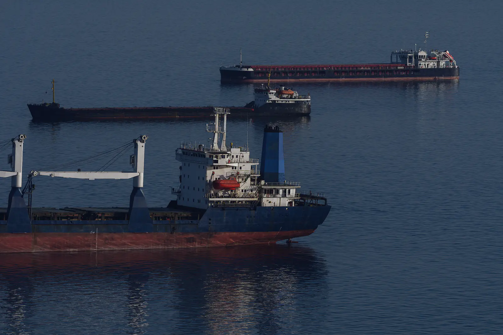 General cargo ships waiting at anchor offshore before their port call