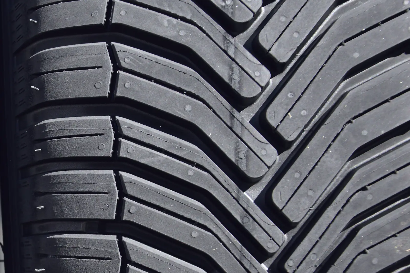 Close view of the deep tread blocks on a new car tyre