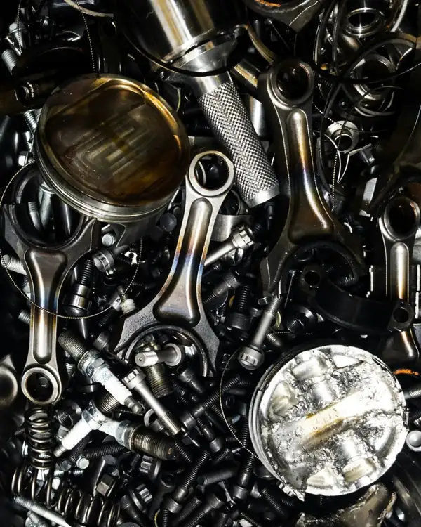 Used engine pistons, connecting rods and bolts collected as scrap