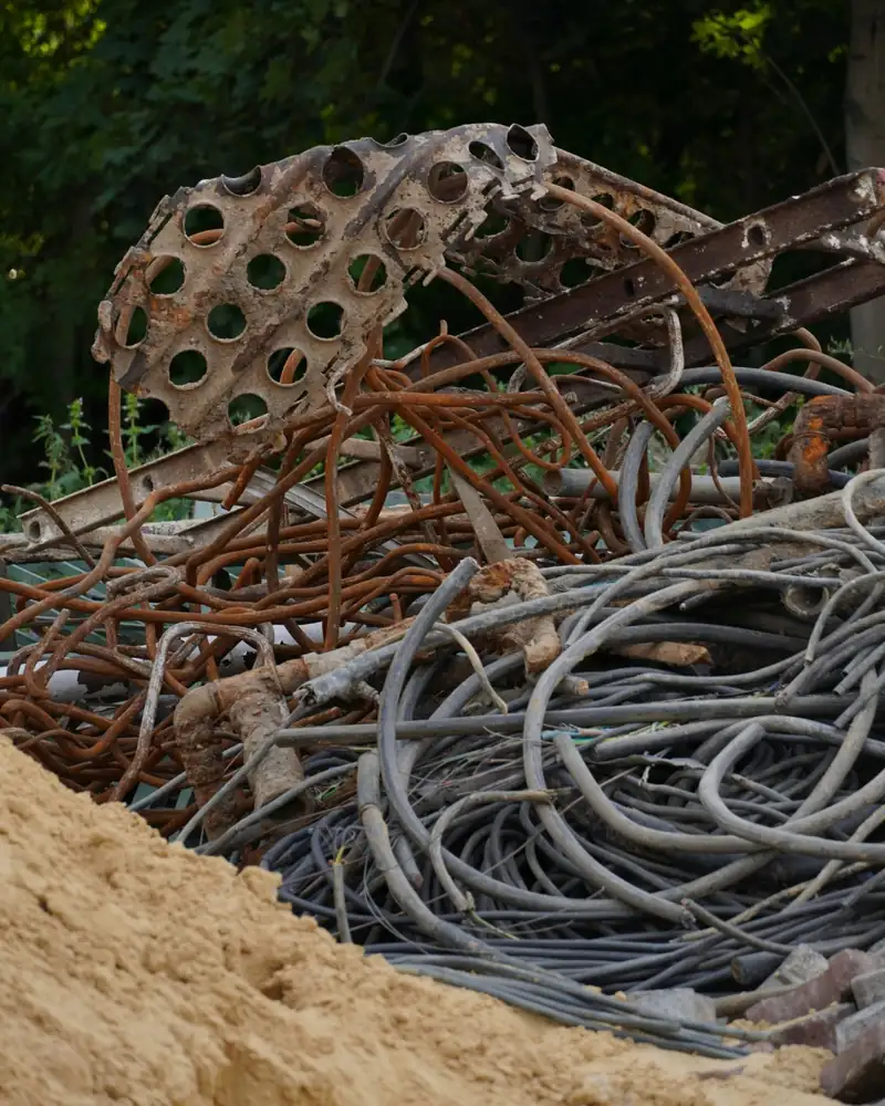 Mixed scrap load of rusted steel rebar, pipe and coiled cable