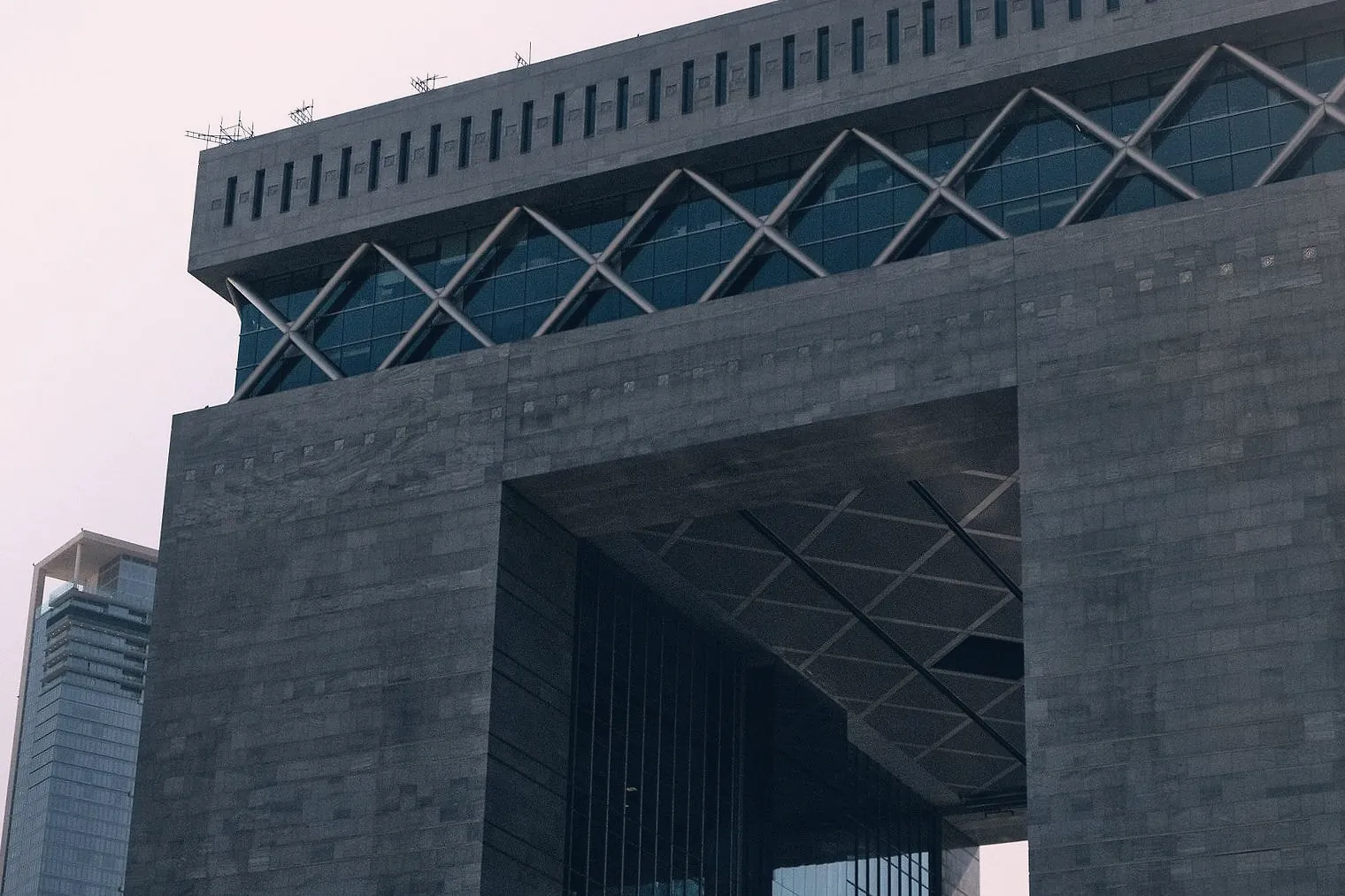 The Gate building in the Dubai International Financial Centre, its lattice facade against a pale sky