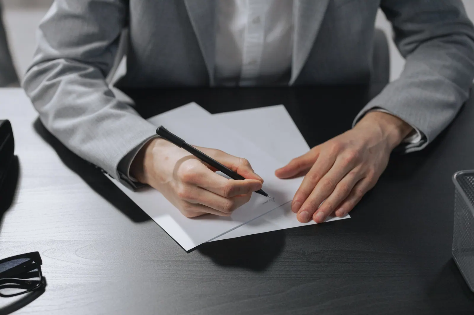 A professional signing a clearance document at a desk